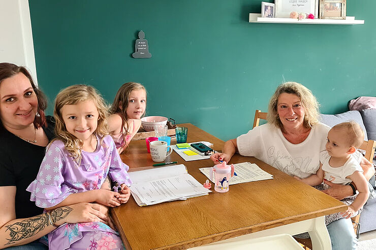 Die Familienpatin besucht die Familie regelmäßig.